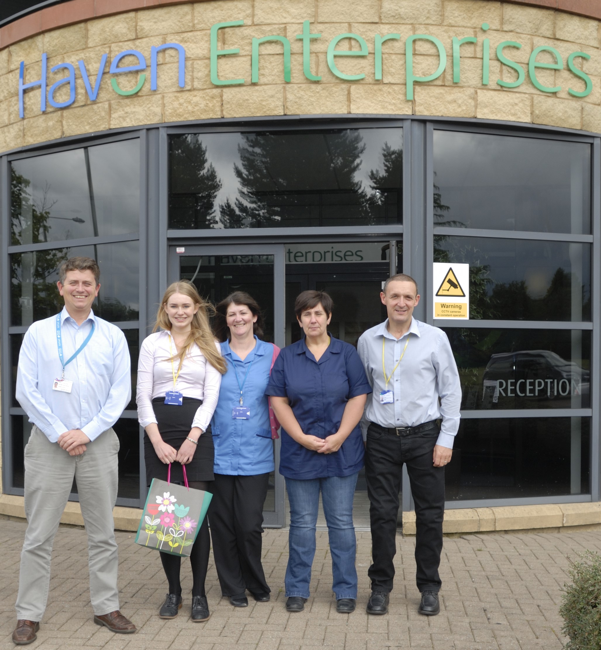 Heather and staff outside Haven PTS factory